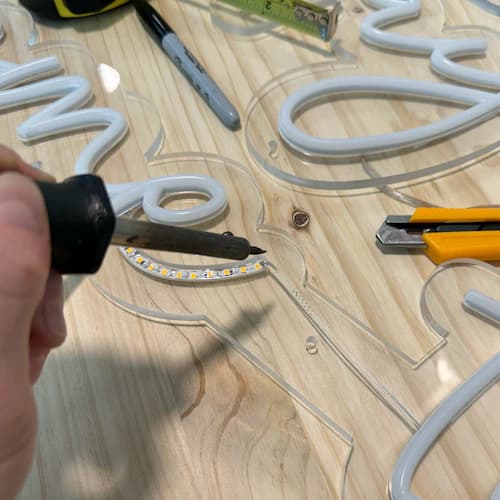 Artesano ensamblando un letrero de neón en el taller